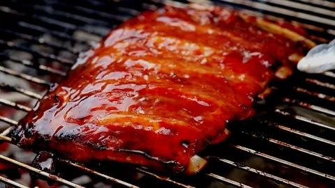 Grilling and flipping pork ribs Stock Footage 88060314