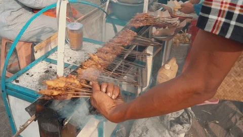 Grilling And Rolling Up Chicken Satay Cooking With Charcoal Stock Footage