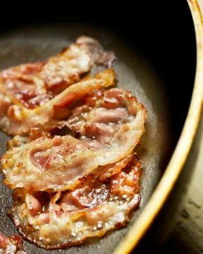 Grilling bacon in a pan Stock Photos
