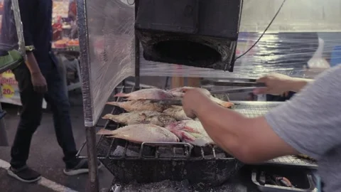 Grilling BBQ Thai Salt Crusted Tilapia Fish, Open Night Street Food Market Stock Footage 237587608