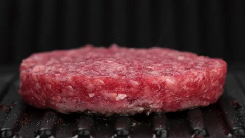 Grilling beef patty for burger close up. Making Tasty Burger Stock Footage 162460350