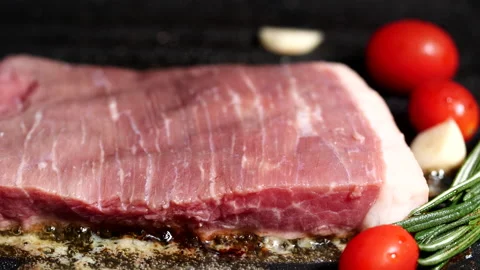 Grilling beef steak, meat steak with rosemary, tomatoes, garlic on iron plate Stock Footage 222775028