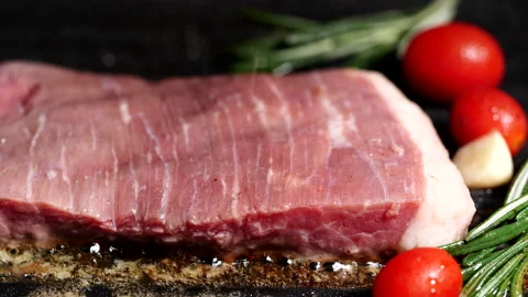 Grilling beef steak, meat steak with rosemary, tomatoes, garlic on iron plate Stock Footage 223171242