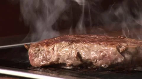 Grilling beefsteak on an electric grill Stock Footage 24634084