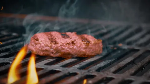 Grilling a burger cutlet.  The cutlet is almost ready. Stock Footage 135386989