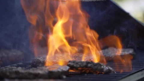 Grilling Burgers with flames Stock Footage 247142992