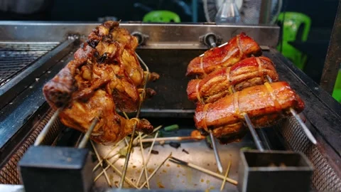 Grilling chicken and pork belly on skewers cooking in a night market, Vietnam Stock Footage 336981973