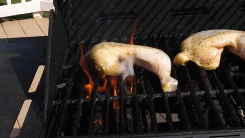 Grilling Chicken with Lemon Pepper with Flames Zoom In Slow Motion Stock Footage 78497164