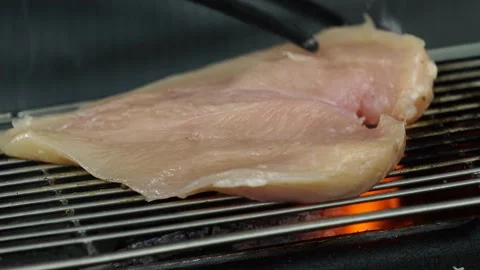 Grilling Chicken over Charcoal Fire 動画素材 334280494