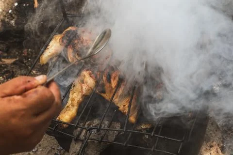 Grilling Chicken Over Open Fire Outdoors 写真素材