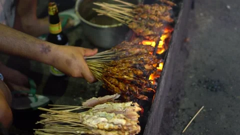 Grilling chicken satay on hot coal Stock Footage 211791482