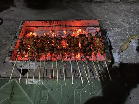 Grilling chicken satay Stock Photos