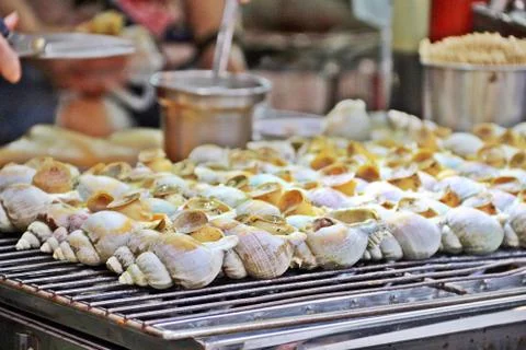 Grilling conch or shellfish as street food Stock Photos