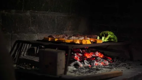 Grilling Different Types of Meat on a Traditional Barbecue along with Vegetables Stock Footage 296515612