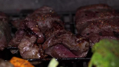 Grilling Different Types of Meat on a Traditional Barbecue along with Vegetables Stock Footage 296515632