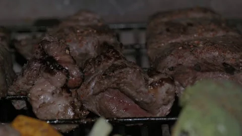 Grilling Different Types of Meat on a Traditional Barbecue along with Vegetables Stock Footage 296515645
