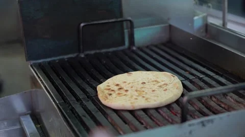 Grilling Fresh, Delicious Flatbread on a Large Commercial Grill Unit Stock Footage 291013119
