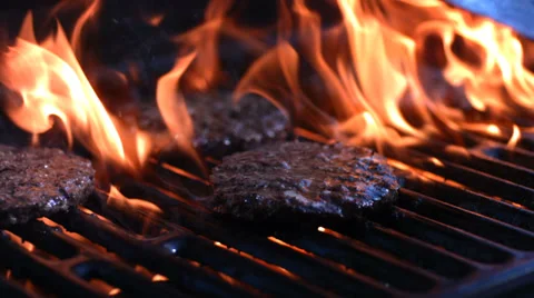 Grilling hamburgers, slow motion Stock Footage