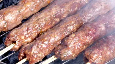 Grilling kebabs on the griil plate. Stock Footage 130096172
