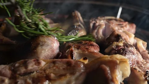 Grilling lamb chops brushing oil  with rosemary on hot smoking BBQ picnic Stock Footage 128453417
