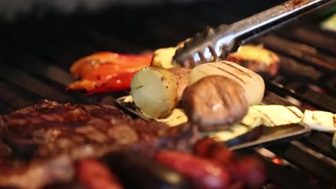 	grilling meat and raw vegetables in a barbecue Stock Footage 131987313