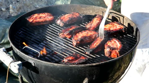 Grilling meat in the backyard - meat looking a bit burned Video stock 40252675