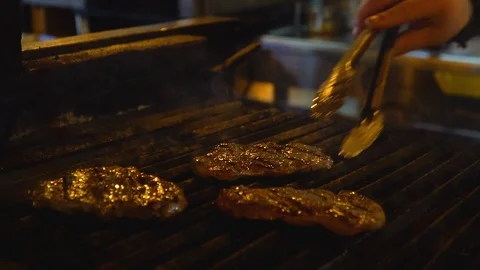Grilling meat on barbecue, close up Stock Footage 107157733