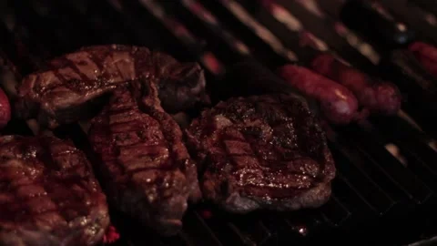 Grilling meat in a barbecue Stock Footage 131988382
