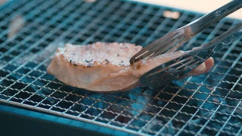 Grilling meat on a grilled plate Stock Footage 113277433