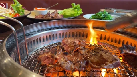 Grilling meat table steak meat with salt and pepper. Beef steak grilled on a Stock Footage 316083334