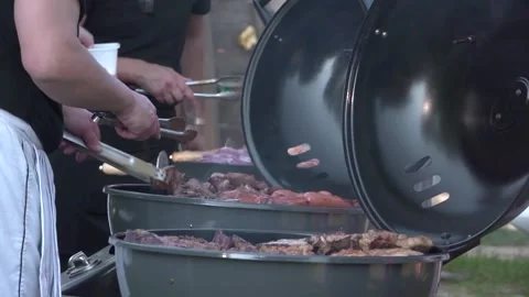 Grilling meats on barbecue grills. Stock Footage 285955697
