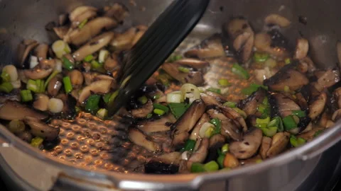 Grilling mushrooms in the pan Stock Footage 153997886