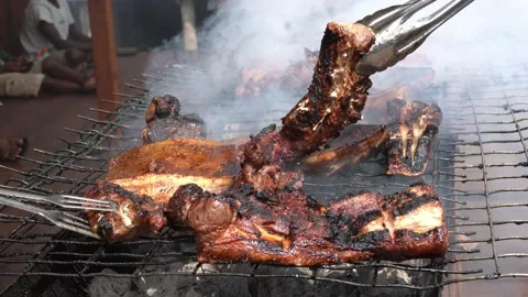 Grilling the pork directly over the fire Stock Footage 228426655