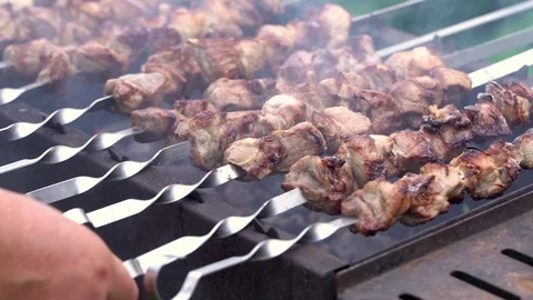 Grilling pork kebab on skewers at bbq Stock Footage