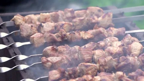 Grilling pork kebab on skewers at bbq Stock Footage