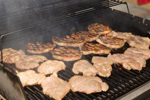 Grilling pork steaks Stock Photos