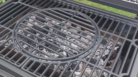 Grilling process after cooking meat shows charcoal ashes and grill cleanlin.. Stock Footage 310495418