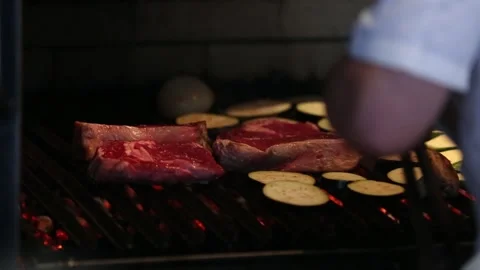 Grilling raw meat and vegetables in a barbecue Stock Footage 131985695