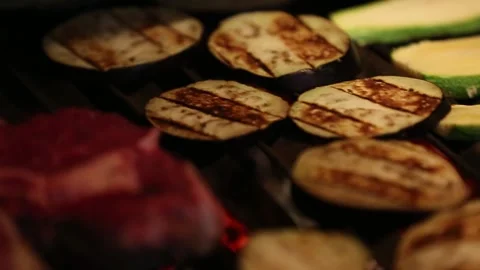 Grilling raw meat and vegetables in a barbecue Stock Footage 131986108