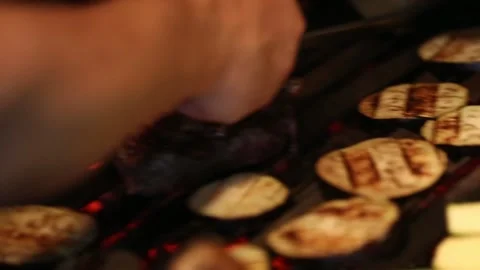 Grilling raw meat and vegetables in a barbecue Stock Footage 131986295