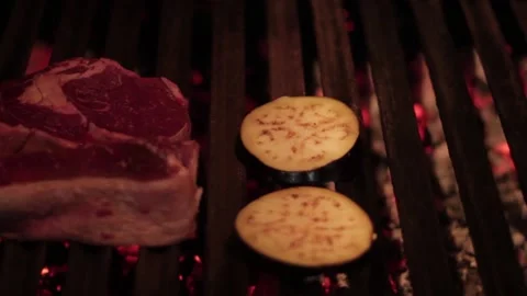 Grilling raw meat and vegetables in a barbecue Stock Footage 131987635