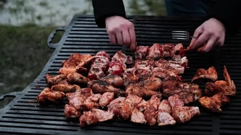 Grilling raw meat on a barbecue, part of cooking classes or lessons, ideal for b Stock Footage 280186554