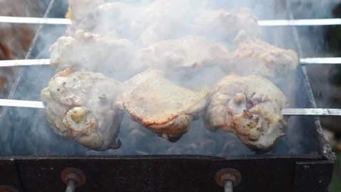Grilling raw meat on outdoor grill Video stock 144311368