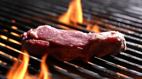 Grilling raw steak meat beef on flaming grill. slow motion Video stock 170316828