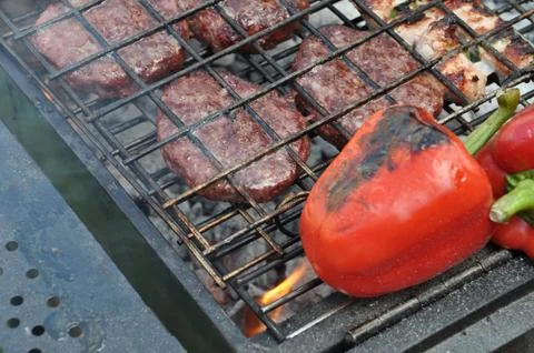 Grilling red peppers Stock Photos