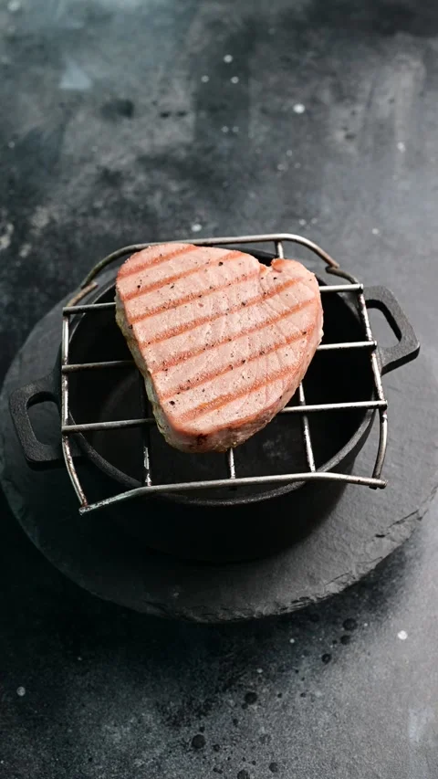 Grilling salmon steak on a cast iron grill pan for a perfect meal experience Stock Footage 305229827