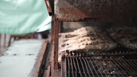 Grilling salted fish stuffed with vegetable herbs Video stock 160277855