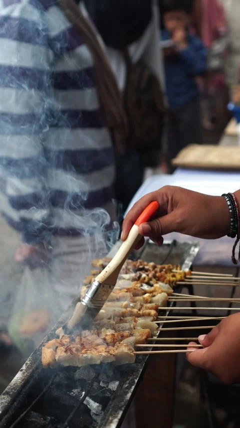 Grilling satay for customers Stock Footage 273227330