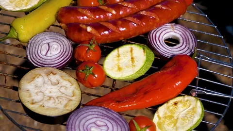 Grilling sausage with vegetables on the griil plate Stock Footage 130097053