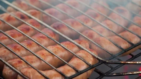 Grilling sausages on the barbecue, close up Video stock 168476953